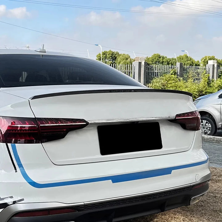 Gloss black rear boot spoiler fitted to an Audi A4 B9 saloon, rear three-quarter view
