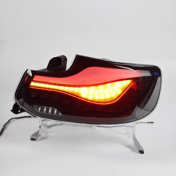 OLED plug and play rear tail lights for BMW 2 Series M2 on a plain background showing indicator lighting