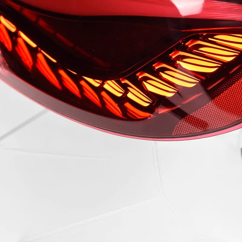OLED red plug and play rear tail lights for BMW 2 Series M2 on a plain background close up