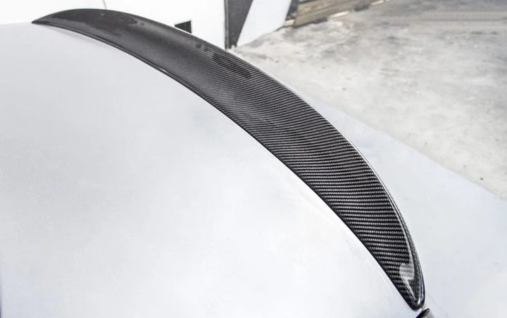 BMW M3 E92 Coupe fitted with a carbon fibre rear spoiler, rear three-quarter view