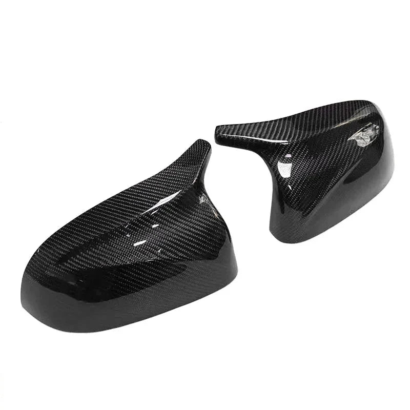 BMW X7 G07 carbon fibre mirror cover close-up showing weave