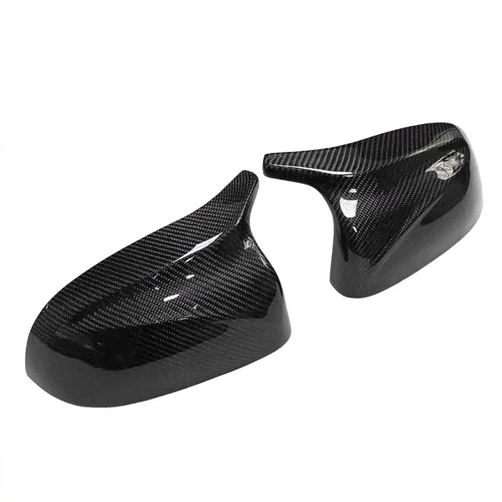 BMW X7 G07 carbon fibre mirror cover close-up showing weave