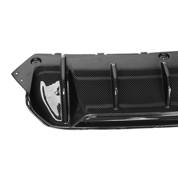BMW M5 F90 V1 carbon fibre rear diffuser on a plain background close up