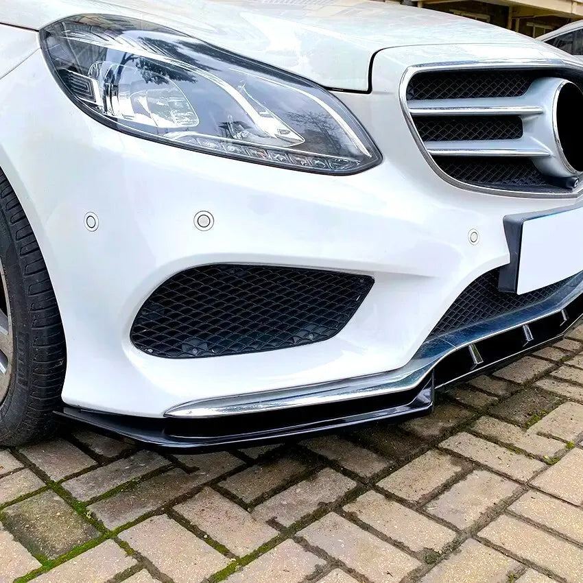 Gloss black 3-piece front splitter fitted to a Mercedes E-Class W212 AMG Line, front three-quarter view
