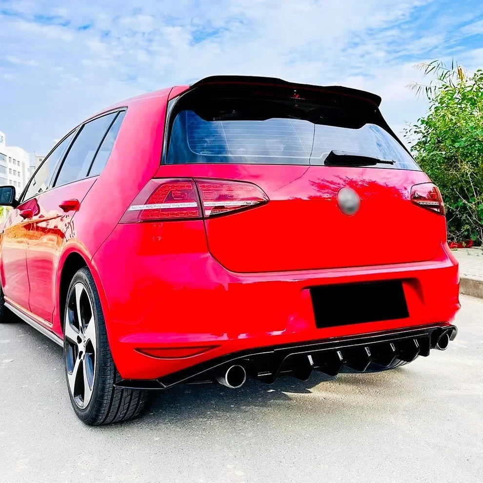 Gloss black rear diffuser fitted to Volkswagen Golf Mk7, three-quarter view